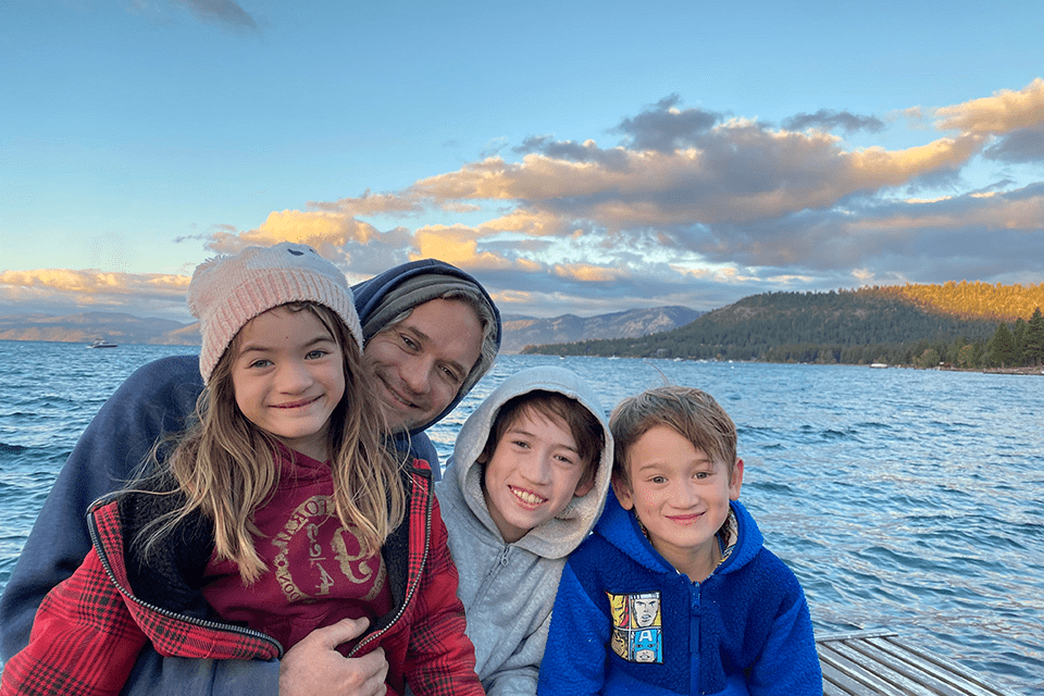 Travis Hoffstetter (A&S ‘05), poses for a photo with his three children.